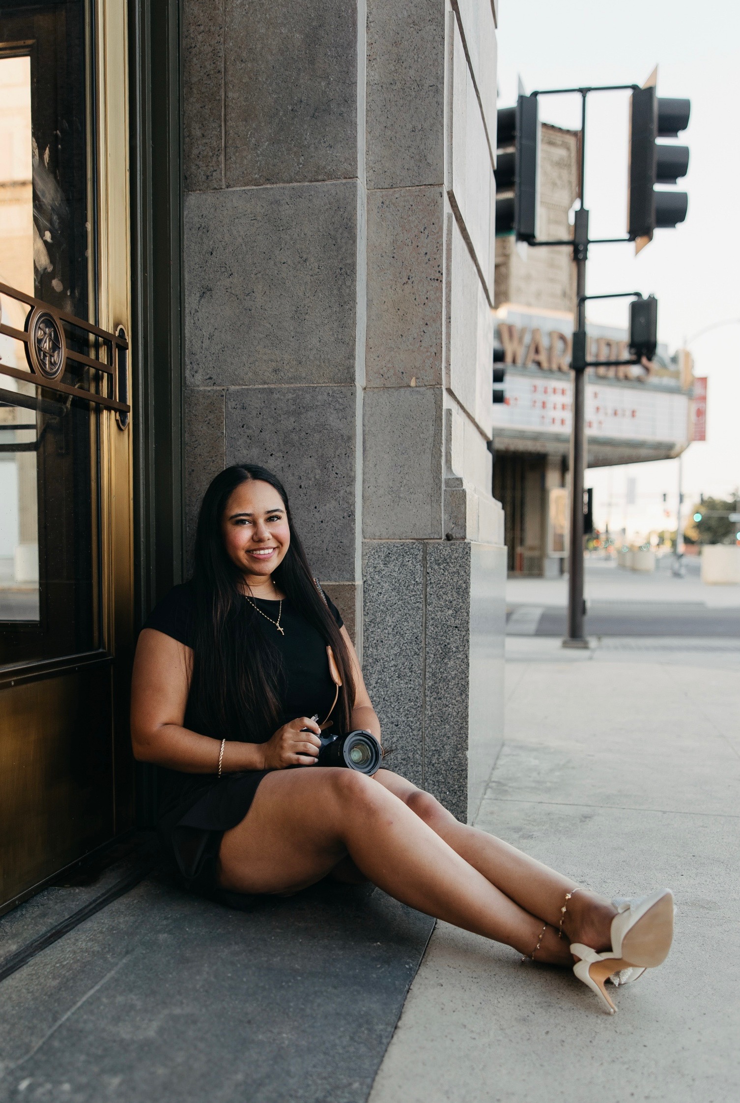 Luz, photographer sitting downtown with camera
